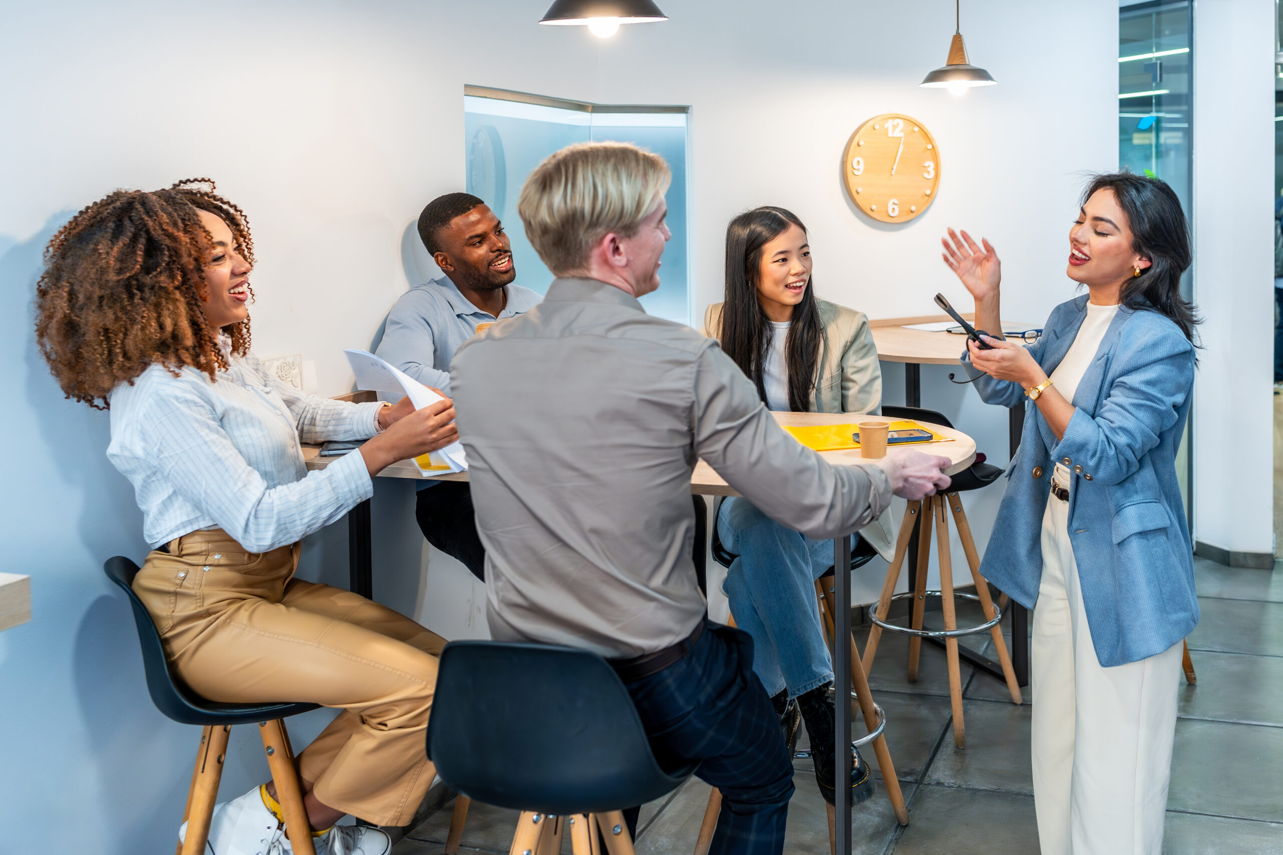 Team collaborating in a modern workspace, discussing ideas and strategies to strengthen brand engagement.