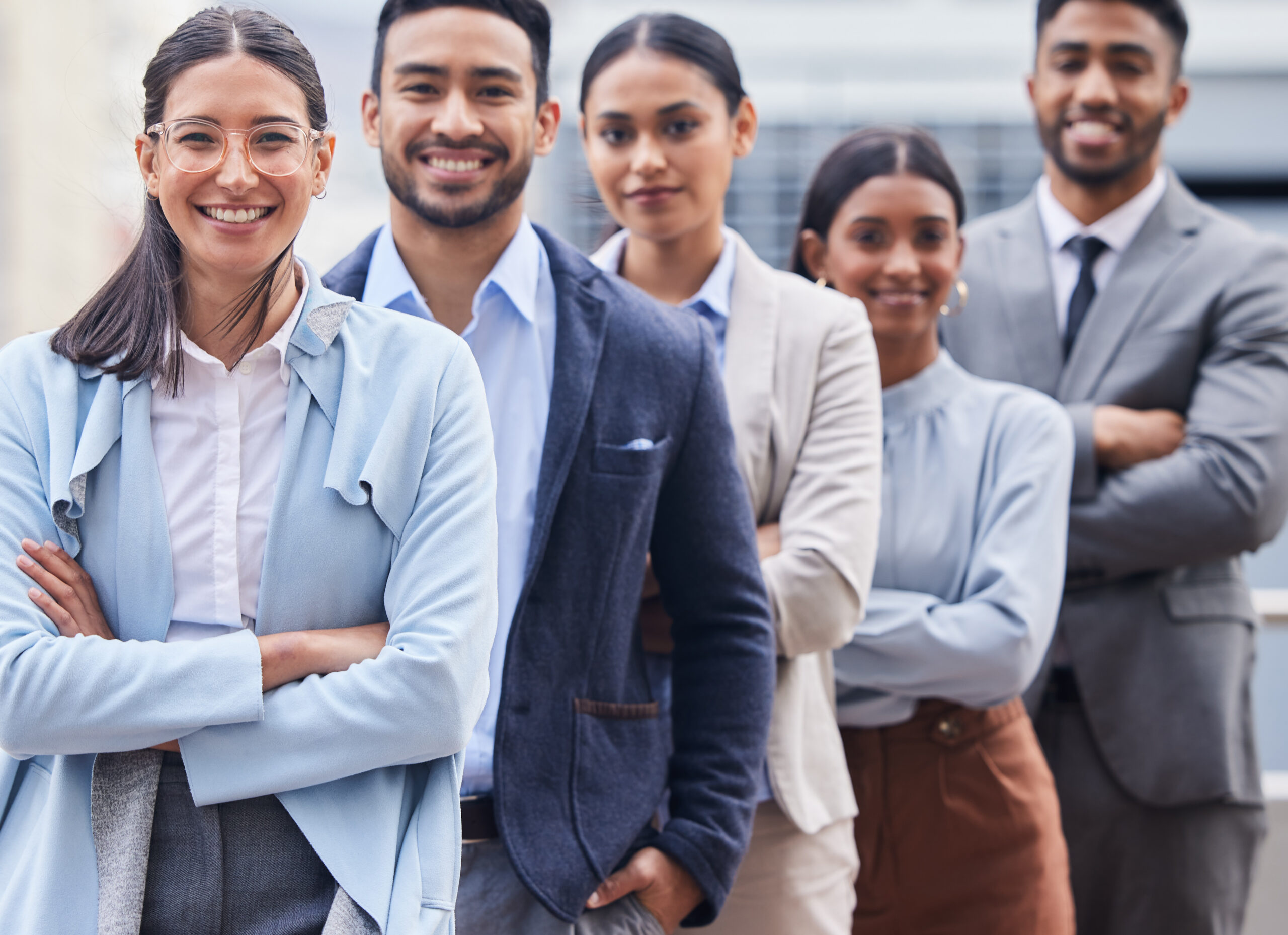 Confident professionals standing together, representing growth opportunities and career paths in sales jobs.